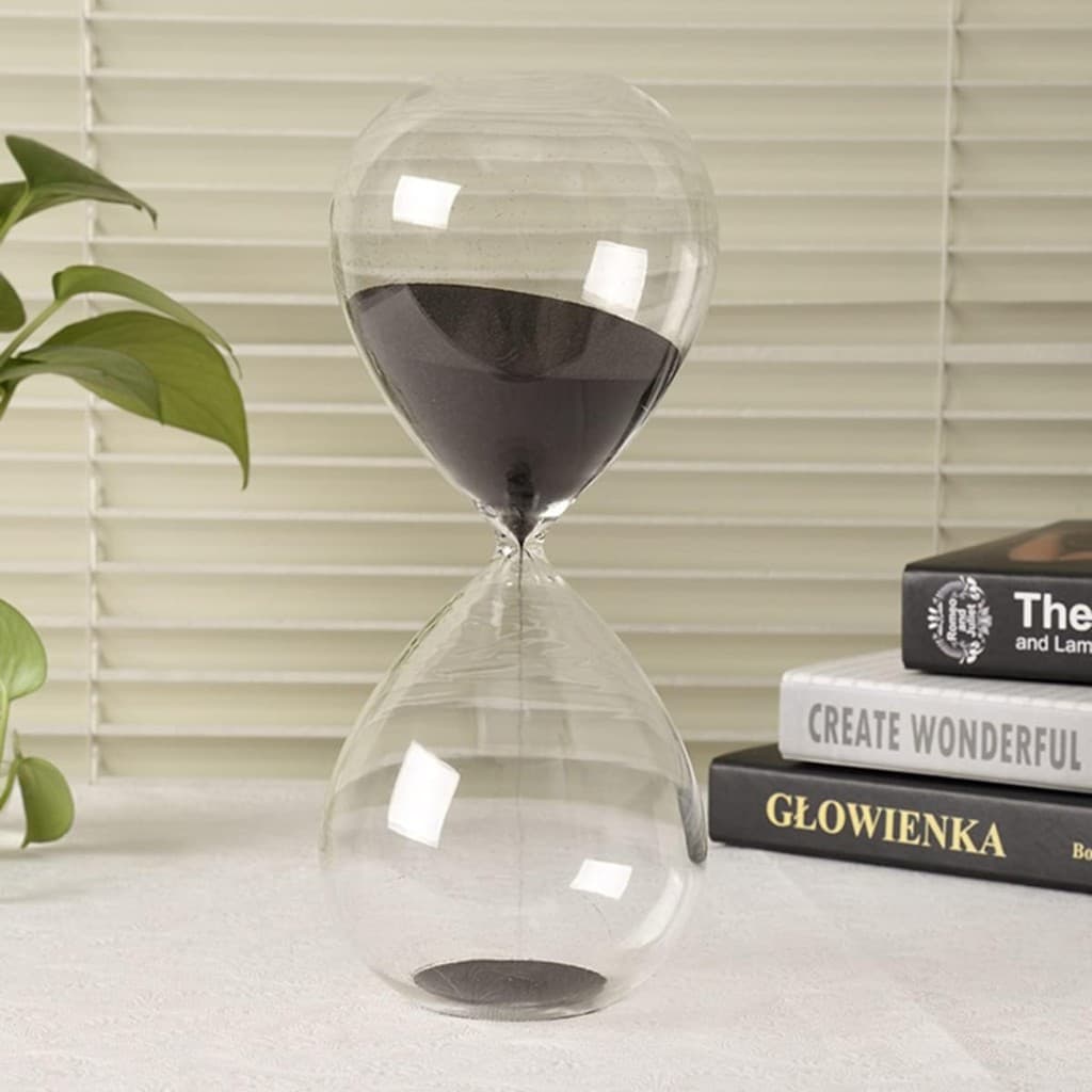 Clear glass hourglass with black sand